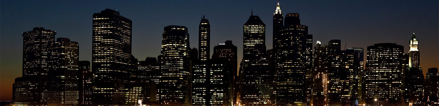Seattle office towers lit at night against a dusk sky